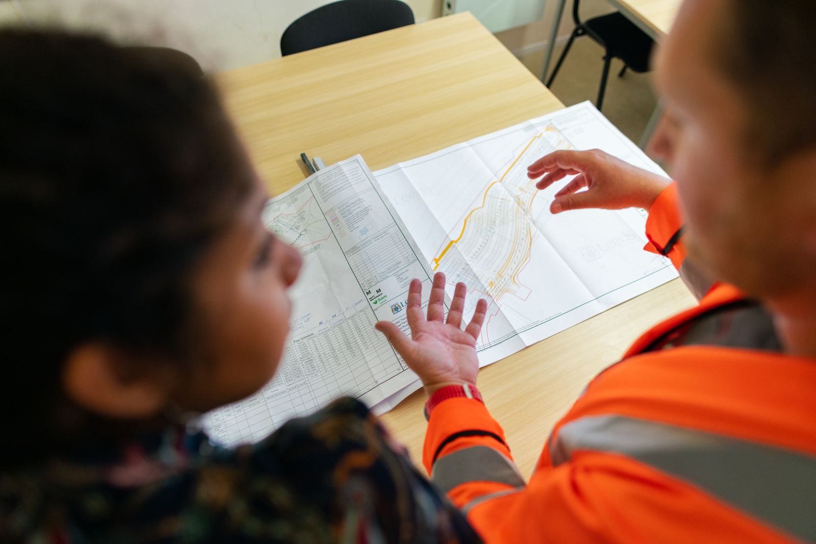 Engineers reviewing manufacturing plans