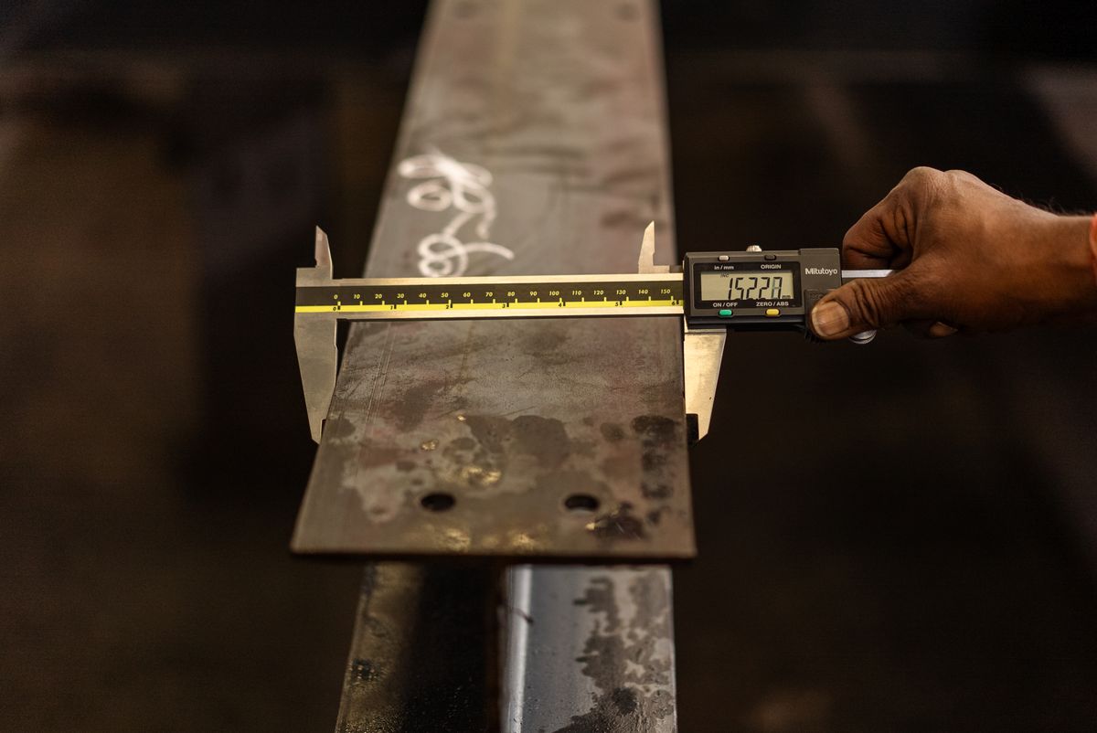 Engineer measuring a component with a digital caliper